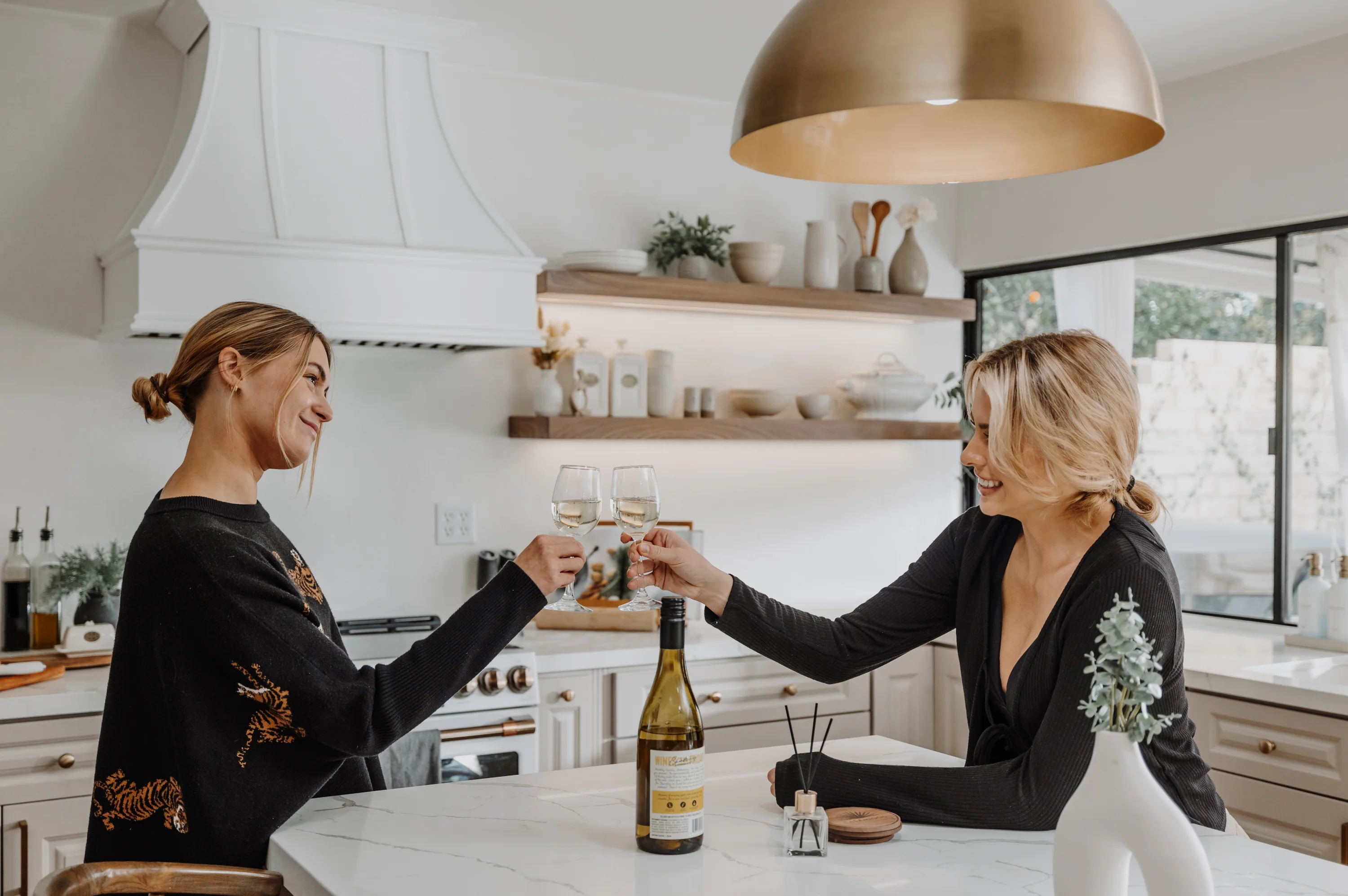 Lyons Crafted team celebrating in a kitchen with custom floating shelves