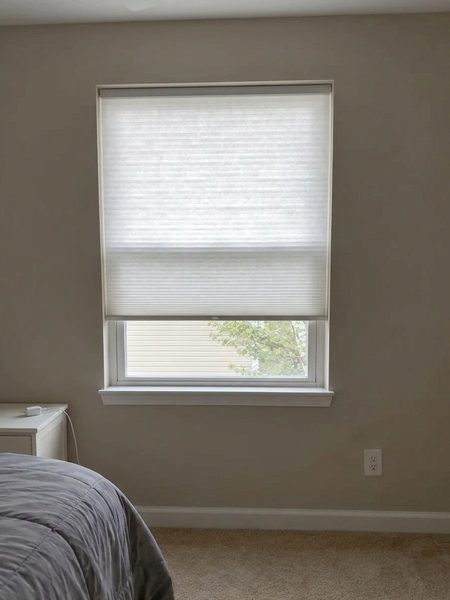 White cellular honeycomb shade previewed on a bedroom window with DecorViz
