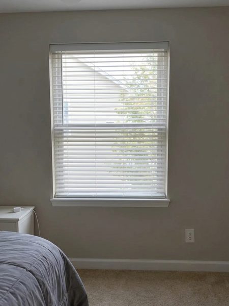 White faux wood blinds previewed on a bedroom window with an AI blinds visualizer