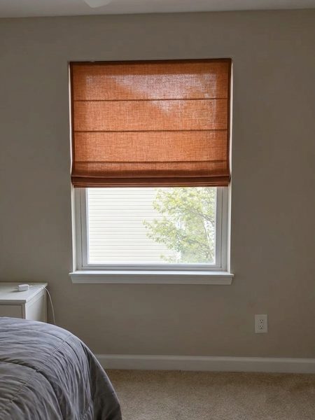 Terracotta linen Roman shade visualized on a bedroom window before buying