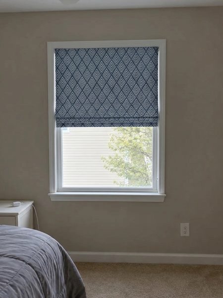 Navy geometric pattern Roman shade previewed on a bedroom window